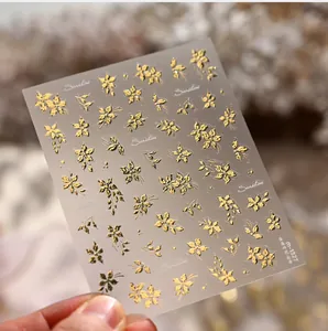 Detailed 3D embossed gold floral nail stickers with marigold design, model M-1327
