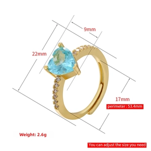 Close-up of heart-cut blue zircon ring with golden band and size dimensions info