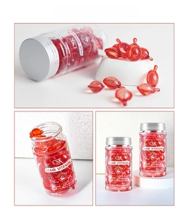 Detailed close-up of red fish-shaped hair vitamin capsules in a 40ml transparent bottle