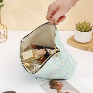 Close-up of holographic lace makeup bag showing large capacity and smooth zipper closure
