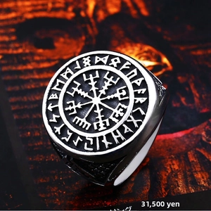 Macro shot of vintage Viking Vegvisir compass ring with Norse runes and aged finish