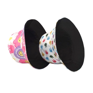 Reversible bucket hats with pink floral smiley and white cartoon rabbit prints