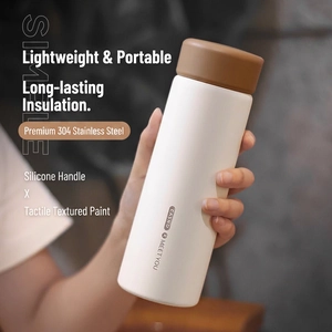 Matte vacuum insulated stainless steel water bottle with silicone handle in cream white