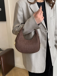 Brown faux suede half-moon tote bag with gold hardware and croc-textured details