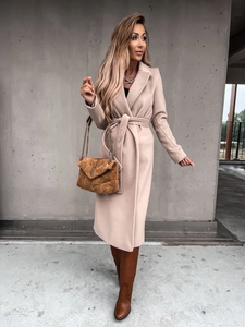 Detailed view of women's beige wool coat featuring wide lapels and matching waist tie