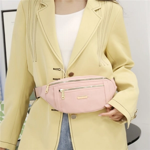 Pink multi-zipper waist bag with adjustable strap and metallic logo plate shown on model