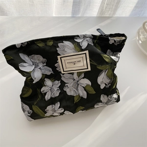 Detail of vintage floral jacquard pouch with Pleasant Time label on white background