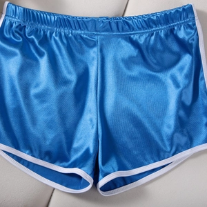 Flat lay of blue satin athletic shorts with white piping and elastic waistband