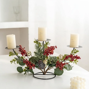 Three-tier Christmas candle holder with artificial pine, red berries and pinecones