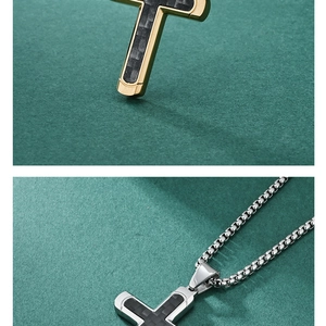 Detail of gold and silver cross pendants with black carbon fiber inlay and box chain