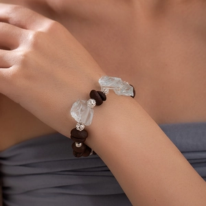 Elegant beaded bracelet with blue stones and coffee bean charms on female wrist