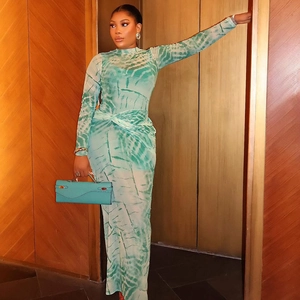 Detail of mint green tie-dye mesh maxi dress with long sleeves and ruched slim fit texture