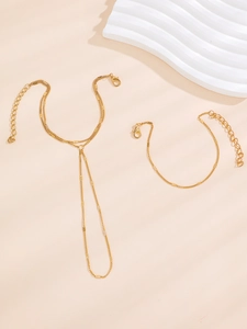 Detail of layered gold finger bracelet set with lobster clasp and adjustable metal link chain