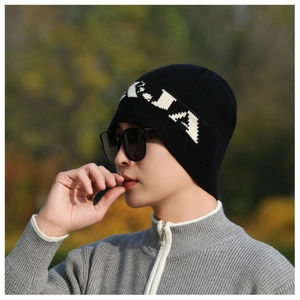 Detail of black knit beanie with white KIA lettering and soft wool texture