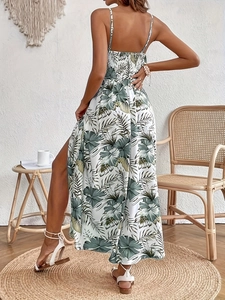 Elegant white summer maxi dress with green floral tropical print and side slit design
