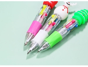 Close-up of multicolor Christmas pens with festive snowman and tree toppers