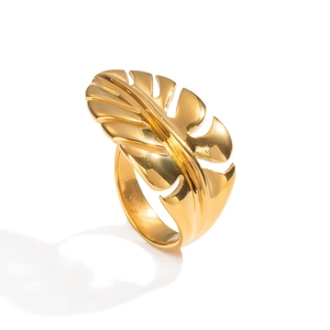 Macro shot of 18K gold monstera leaf ring showing detailed metal texture and design