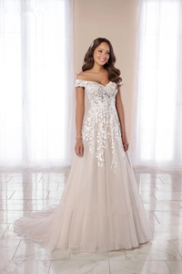 Detail of off-the-shoulder neckline with delicate floral lace appliques on evening gown