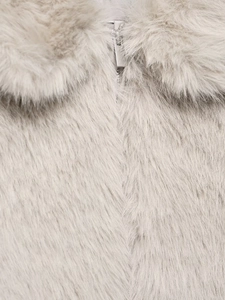 Close-up of the plush faux fur texture and silver metal zipper on this stylish short jacket
