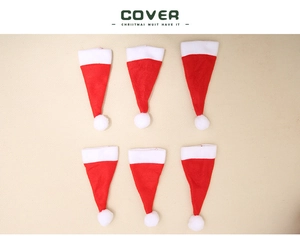 Detailed overhead view of six mini red and white non-woven Christmas hat utensil covers