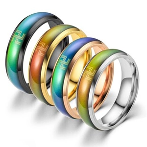 Macro detail of rainbow gradient inlay and golden symbols on four-color cable bracelets