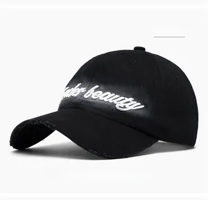 Detail of black cotton baseball cap featuring under beauty embroidery and distressed brim