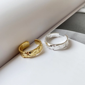Detailed view of silver and gold S925 sterling silver rings with lava texture