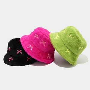 Chic plush bucket hats with ribbon bows in black, vibrant pink, and bright green colors