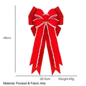 Large red flocked burlap Christmas bow with white trim and gold bell for tree decoration