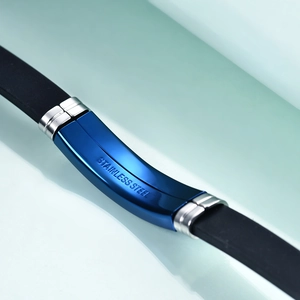 Detailed macro view of deep blue stainless steel finish and durable black silicone strap