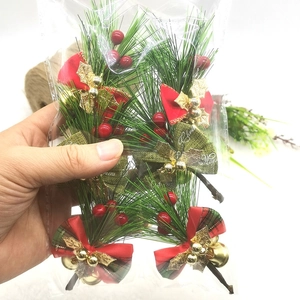 Artificial Christmas pine needles with red berries and gold bells in a pack of four