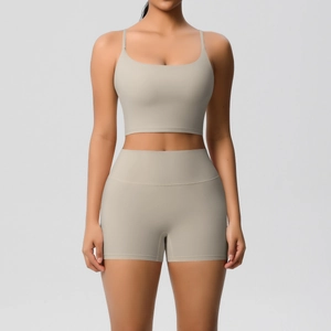Close-up of seamless light khaki yoga set with thin straps and high-waist shorts