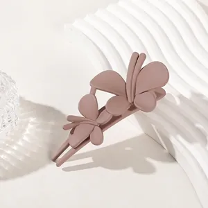 Detailed view of 3D butterfly matte hair claw clip in elegant dusty rose brown color