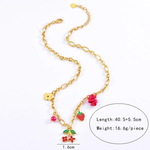 Detailed view of golden strawberry and cherry enamel pendants on a thick chain necklace