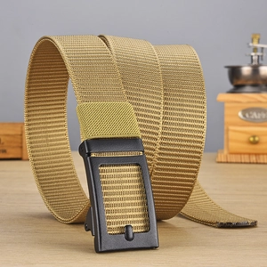 Detailed view of khaki nylon tactical belt with matte black automatic buckle on wood
