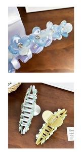 Macro detail of rhinestone-studded floral hair claw clips in macaron colors and acrylic