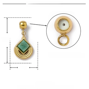 Macro detail of gold stainless steel pendant with green stone and internal rubber stopper
