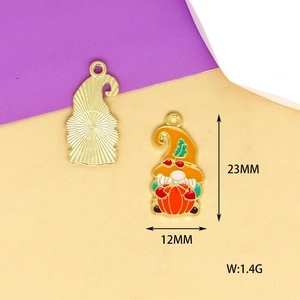 Detail view showing front and back of gnome with pumpkin pendant, 23mm x 12mm enamel charm