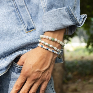 Three-piece men's beaded bracelet set featuring pearls, turquoise, and evil eye charms