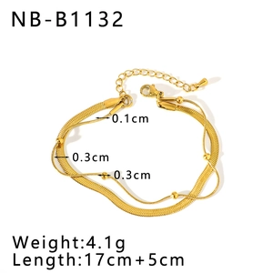 Detailed view of layered gold snake chain and beaded bracelet with size measurements