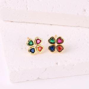 18K gold four-leaf clover stud earrings with colorful zircon stones on stone background