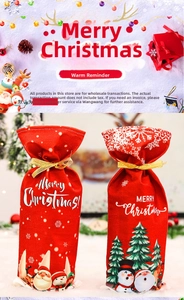Detail of Christmas wine gift bags with Santa patterns and golden ribbon drawstrings