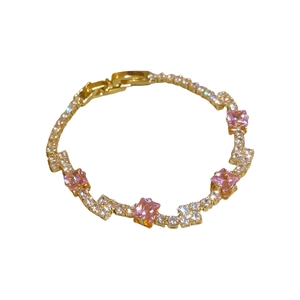 Elegant gold-plated bracelet featuring square pink gemstones and sparkling zircon accents