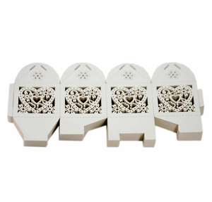 Flat lay of laser-cut heart pattern gift boxes in cream paper before assembly