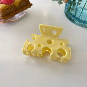 Cute yellow cheese-shaped acetate hair claw clip with a realistic hollow hole design