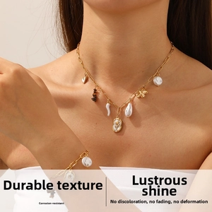 Detail of vintage gold necklace and bracelet set with baroque pearls and tulip relief