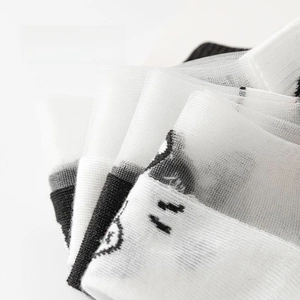 Macro detail of breathable ice-silk mesh fabric with minimalist cartoon face pattern