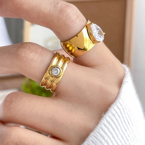 Detail of 18K gold plated titanium ring with large pear and round cubic zirconia stones