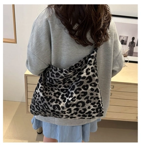 Rear view of model wearing leopard print tote bag in dark grey canvas for work