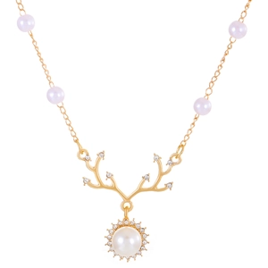 Golden reindeer necklace with pearls and sparkling crystals on a white background